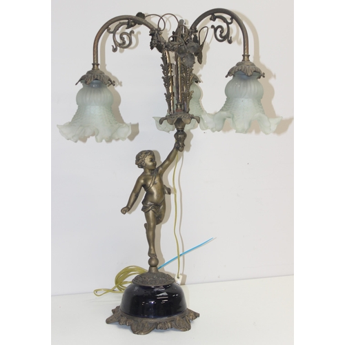 250 - An antique brass and ceramic 3 piece table lamp formed as a boy holding all 3 lamps with foliage des... 