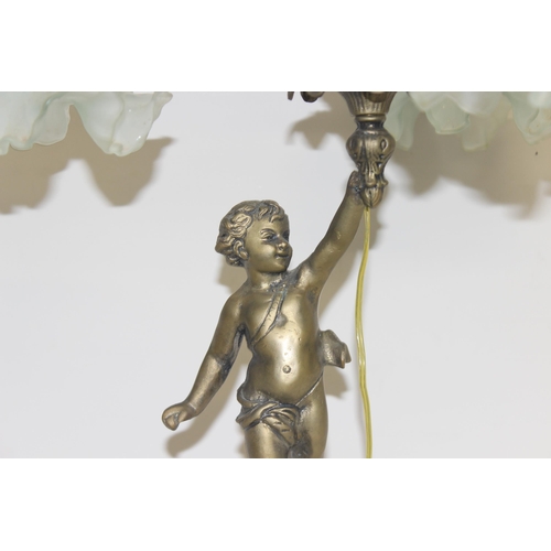 250 - An antique brass and ceramic 3 piece table lamp formed as a boy holding all 3 lamps with foliage des... 