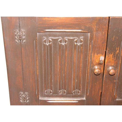 159 - An antique style oak 2 door and 2 drawer side cabinet with shaped iron hinges, approx 81cm wide x 46... 