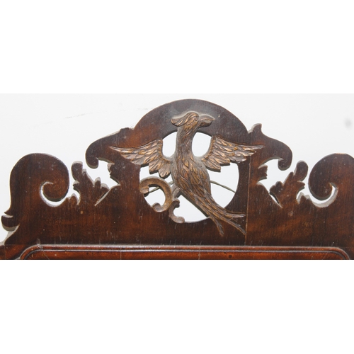 626 - A Georgian mahogany framed fretwork mirror with carved eagle design, approx 82cm x 50cm