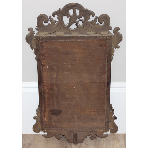 626 - A Georgian mahogany framed fretwork mirror with carved eagle design, approx 82cm x 50cm