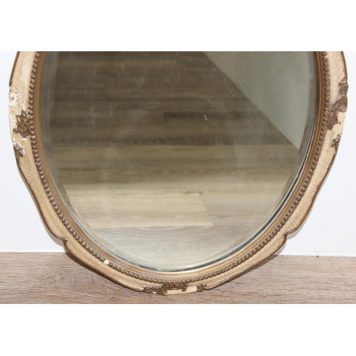 596 - 2 mirrors to incl an oval shaped easel-backed mirror with beaded frame, and a wooden-framed wall mir... 