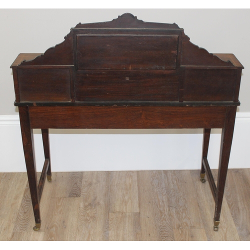 8 - In the manner of James Shoolbred, a 19th century rosewood writing desk with 2 banks of 2 small drawe... 