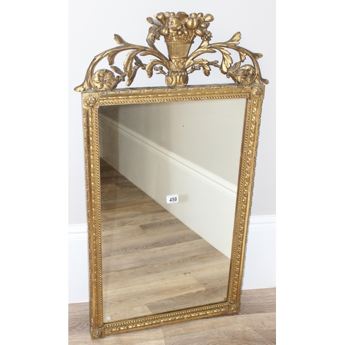 458 - Antique gilt framed mirror with decorative carved wooden fruit and scrolls to top, likely 19th centu... 