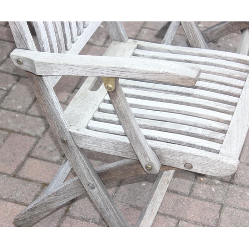 321 - Teak garden set by Gloster of Bristol comprising of round table with 6 folding chairs approx diamete... 