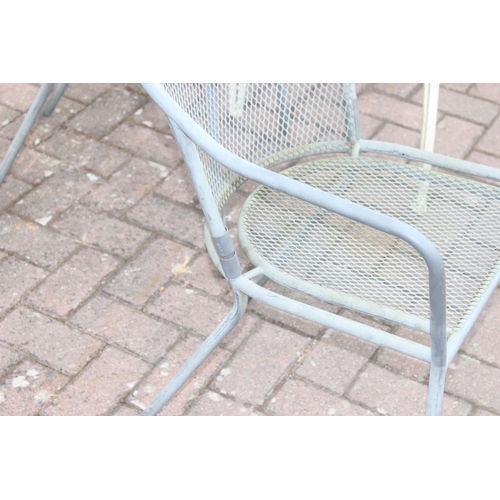 329 - White painted metal round garden table with rocket style base, and a set of 4 metal garden chairs, t... 