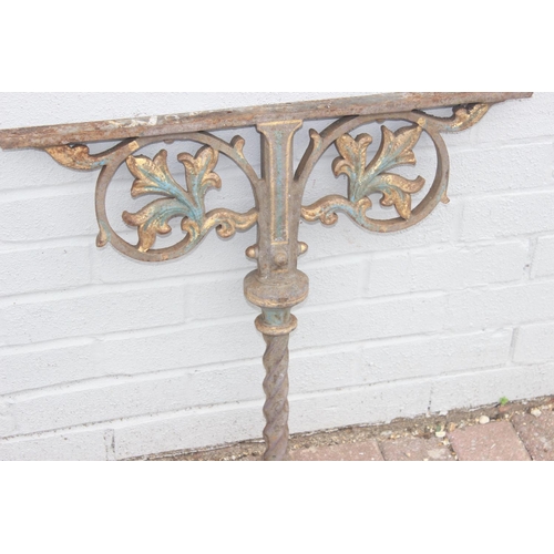 344 - Pair of cast iron table base legs with Fleur de Lys motifs and twisted supports, each with part pain... 