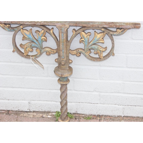 344 - Pair of cast iron table base legs with Fleur de Lys motifs and twisted supports, each with part pain... 