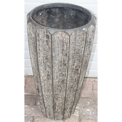 352 - 2 fiberglass garden planters of ribbed bark effect form, the largest approx 46cm x 92cm