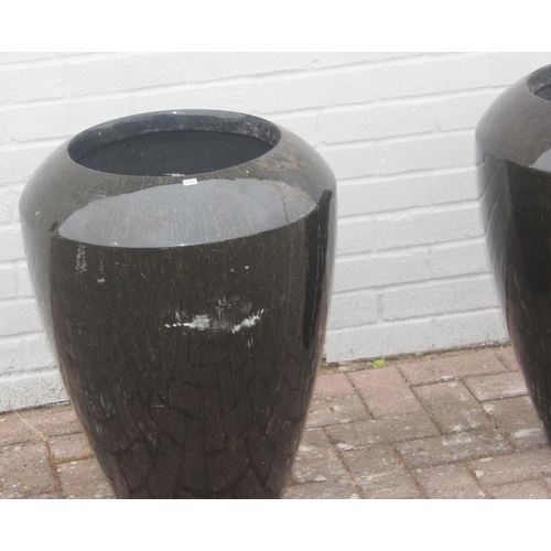 357 - A pair of black streaky glaze effect fiberglass garden planters, each approx 50cm x 68cm tall