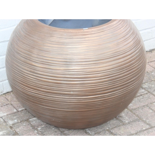 363 - A copper coloured fiberglass planter of spherical form with ribbed textured design, approx 65cm wide... 