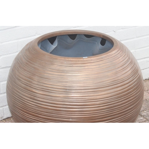 363 - A copper coloured fiberglass planter of spherical form with ribbed textured design, approx 65cm wide... 