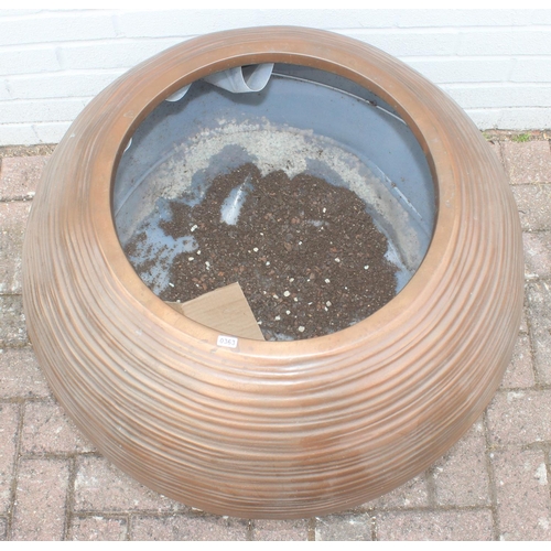 363 - A copper coloured fiberglass planter of spherical form with ribbed textured design, approx 65cm wide... 