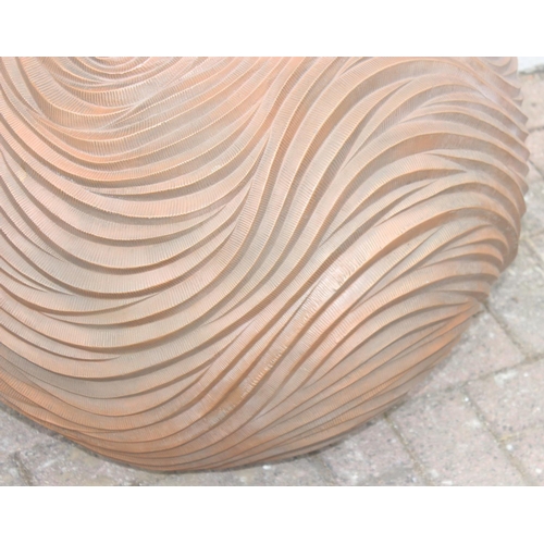 364 - A copper coloured fiberglass planter of spherical form with wavy textured design, approx 65cm wide x... 