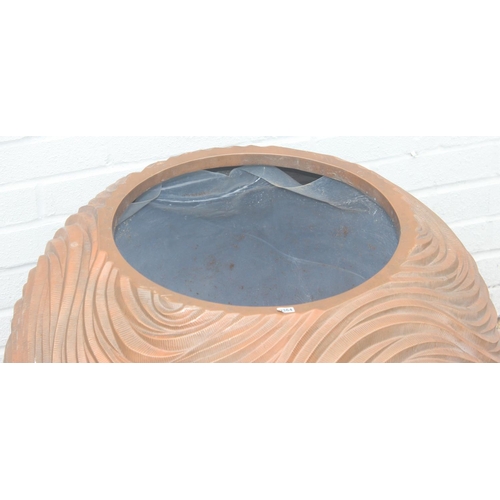 364 - A copper coloured fiberglass planter of spherical form with wavy textured design, approx 65cm wide x... 