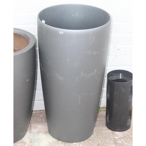 367 - 3 graphite grey coloured fiberglass or plastic garden planters of various forms, the largest approx ... 