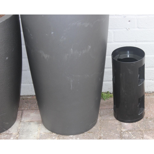 367 - 3 graphite grey coloured fiberglass or plastic garden planters of various forms, the largest approx ... 