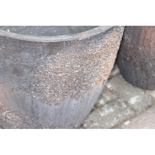 372 - A pair of interesting textured garden planters of circular tapered form, each approx 43cm in diamete... 