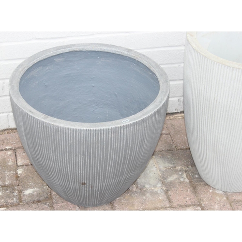 373 - 2 grey pottery garden planters with fluted design, the tallest approx 40cm in diameter x 55cm tall