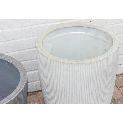 373 - 2 grey pottery garden planters with fluted design, the tallest approx 40cm in diameter x 55cm tall