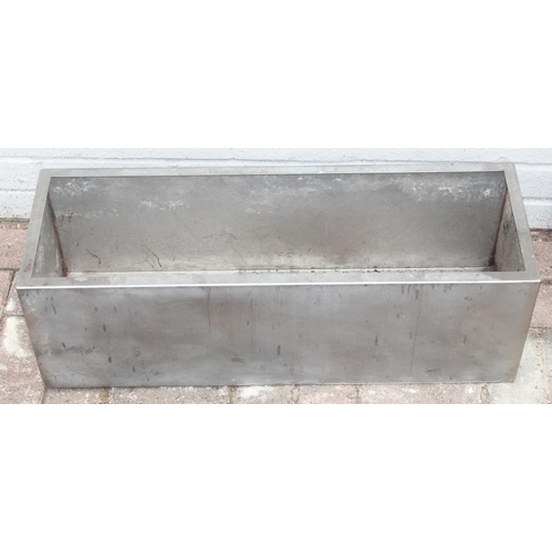 375 - 2 stainless steel trough shaped garden planters, the largest approx 67cm x 34cm x 38cm tall