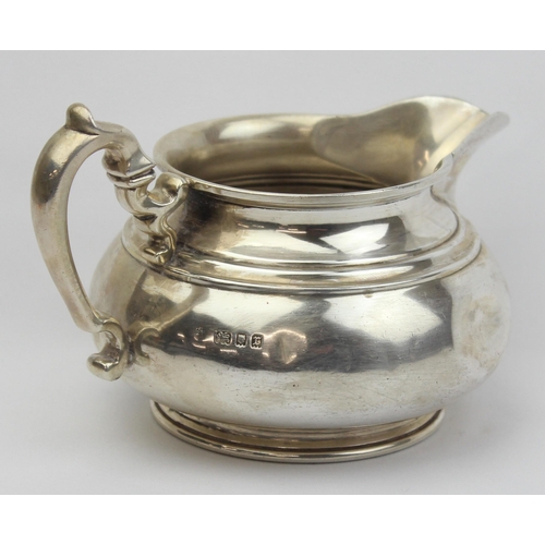 1002 - A vintage silver 2 handled milk or cream jug, London 1932 by Edward Barnard & Sons Ltd, approx 14cm ... 