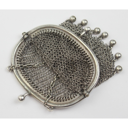 1013 - An early 20th century silver chainmail purse with suspension ring, indistinctly marked but XRF confi... 