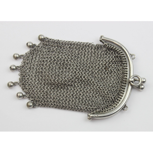 1013 - An early 20th century silver chainmail purse with suspension ring, indistinctly marked but XRF confi... 