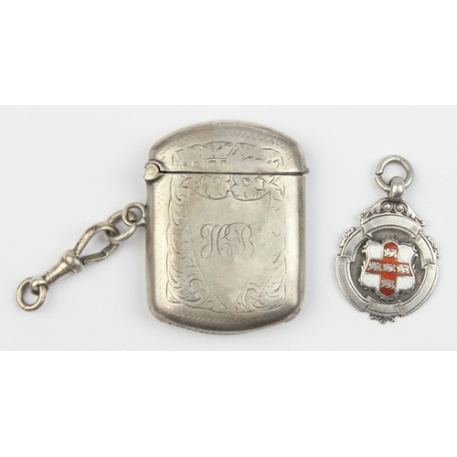 1018 - An antique silver vesta case with engraved decoration, Birmingham 1920, and a silver and enamel fob ... 