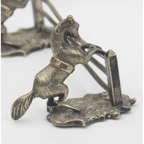 1029 - A pair of antique silver plated knife rests formed as a pair of horses jumping a 3 bar fence, each u... 