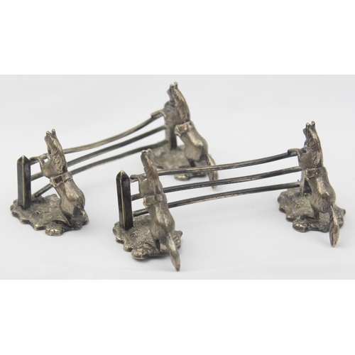 1029 - A pair of antique silver plated knife rests formed as a pair of horses jumping a 3 bar fence, each u... 