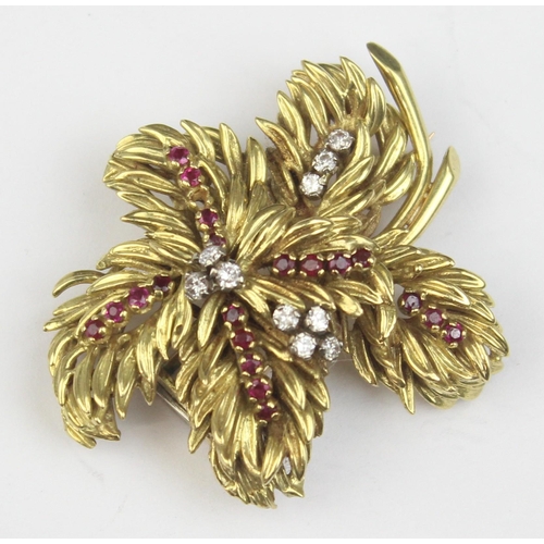 1104 - In the manner of Tiffany & Co, a retro 18ct gold ruby and diamond brooch formed as leaves or feather... 