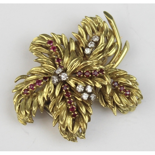 1104 - In the manner of Tiffany & Co, a retro 18ct gold ruby and diamond brooch formed as leaves or feather... 