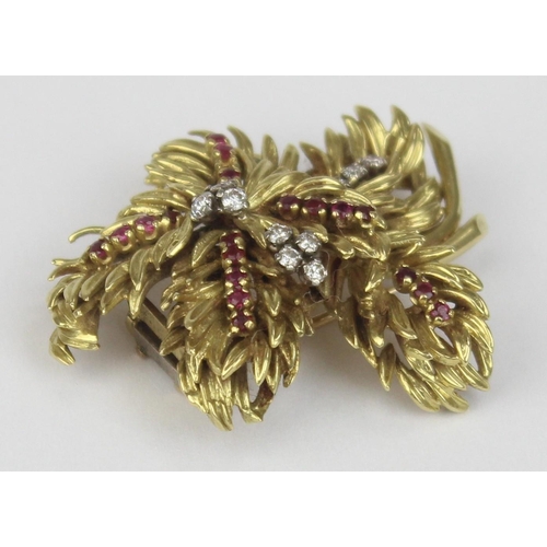 1104 - In the manner of Tiffany & Co, a retro 18ct gold ruby and diamond brooch formed as leaves or feather... 