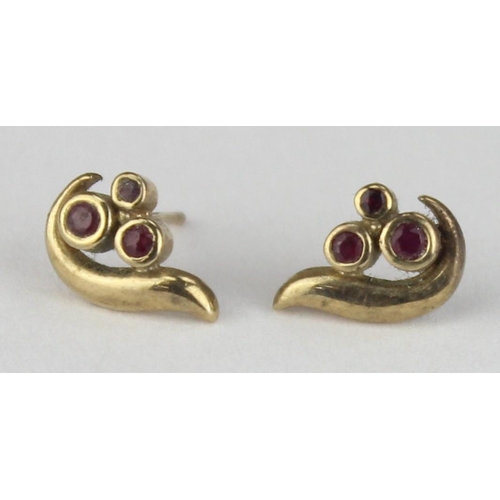 1112 - A pair of retro style 9ct gold and ruby earring, each stud set with 3 small rubies in a flame style ... 