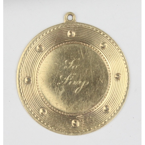 1123 - A 14ct gold engraved pendant, marked 14k and XRF confirmed, approx 32mm in diameter, approx 6.61g gr... 