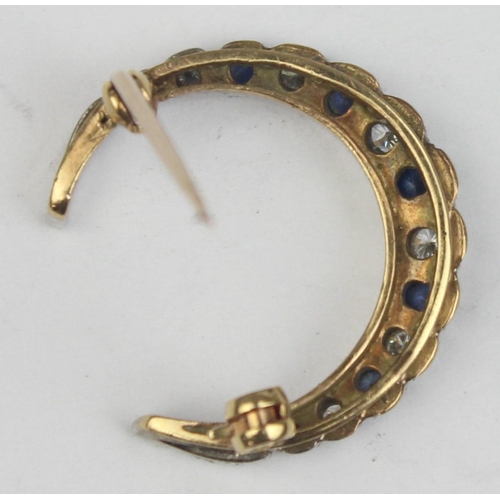 1140 - A 9ct gold crescent brooch set with blue and white stones, believed to be diamonds and sapphires, se... 