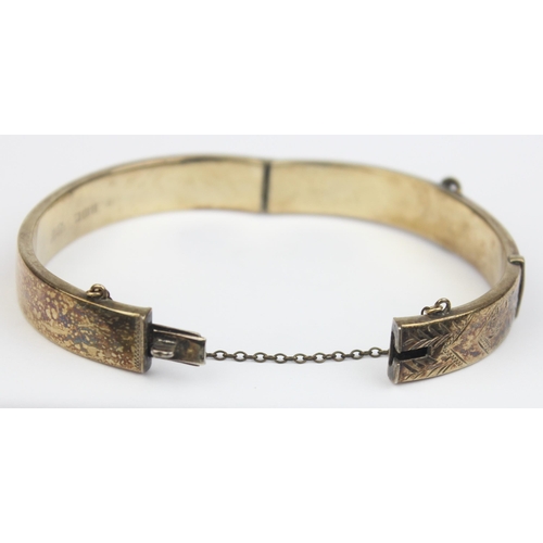 1153 - A mid-century silver gilt cuff bangle formed as a belt, marked for Birmingham 1971, marked 22ct gold... 