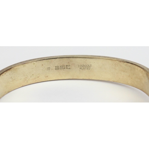 1153 - A mid-century silver gilt cuff bangle formed as a belt, marked for Birmingham 1971, marked 22ct gold... 