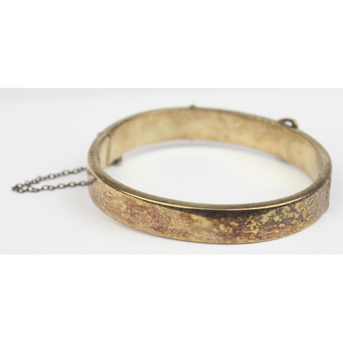 1153 - A mid-century silver gilt cuff bangle formed as a belt, marked for Birmingham 1971, marked 22ct gold... 