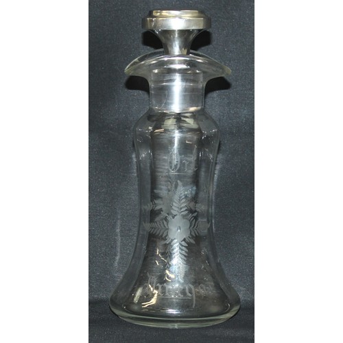 1027 - An antique silver topped oil and vinegar bottle, the glass body with engraved decoration, the top ma... 