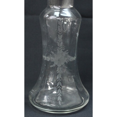 1027 - An antique silver topped oil and vinegar bottle, the glass body with engraved decoration, the top ma... 