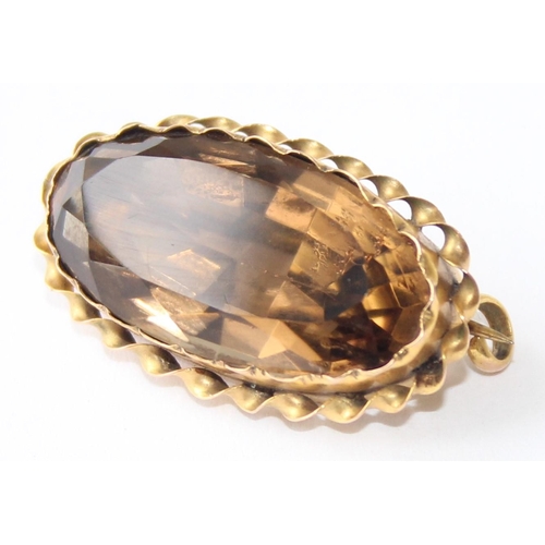 1165 - An antique 9ct gold mounted brooch set with smoky quartz coloured cut stone, approx 28mm wide, appro... 