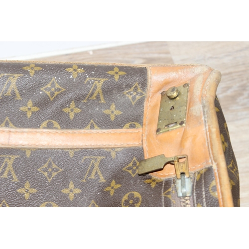 273 - A genuine Louis Vuitton leather and monogrammed suitcase, inscribed in gilt 'DE