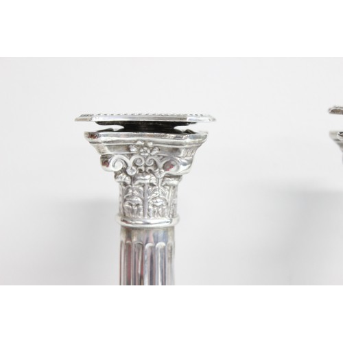 1005 - A pair of large and impressive silver Corinthian column candlesticks, marked for Birmingham 1935, ea... 