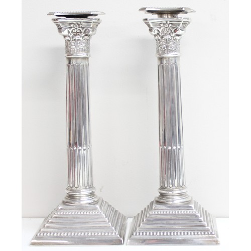 1005 - A pair of large and impressive silver Corinthian column candlesticks, marked for Birmingham 1935, ea... 