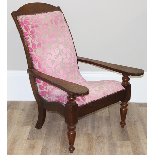 23 - An antique plantation chair with turned legs and later retro style pink floral upholstery, approx 10... 