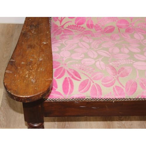 23 - An antique plantation chair with turned legs and later retro style pink floral upholstery, approx 10... 