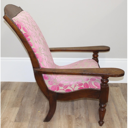 23 - An antique plantation chair with turned legs and later retro style pink floral upholstery, approx 10... 