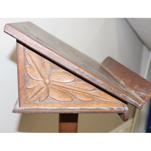 25 - A vintage oak lectern with carved details, approx 40cm wide x 40cm deep x 124cm tall
